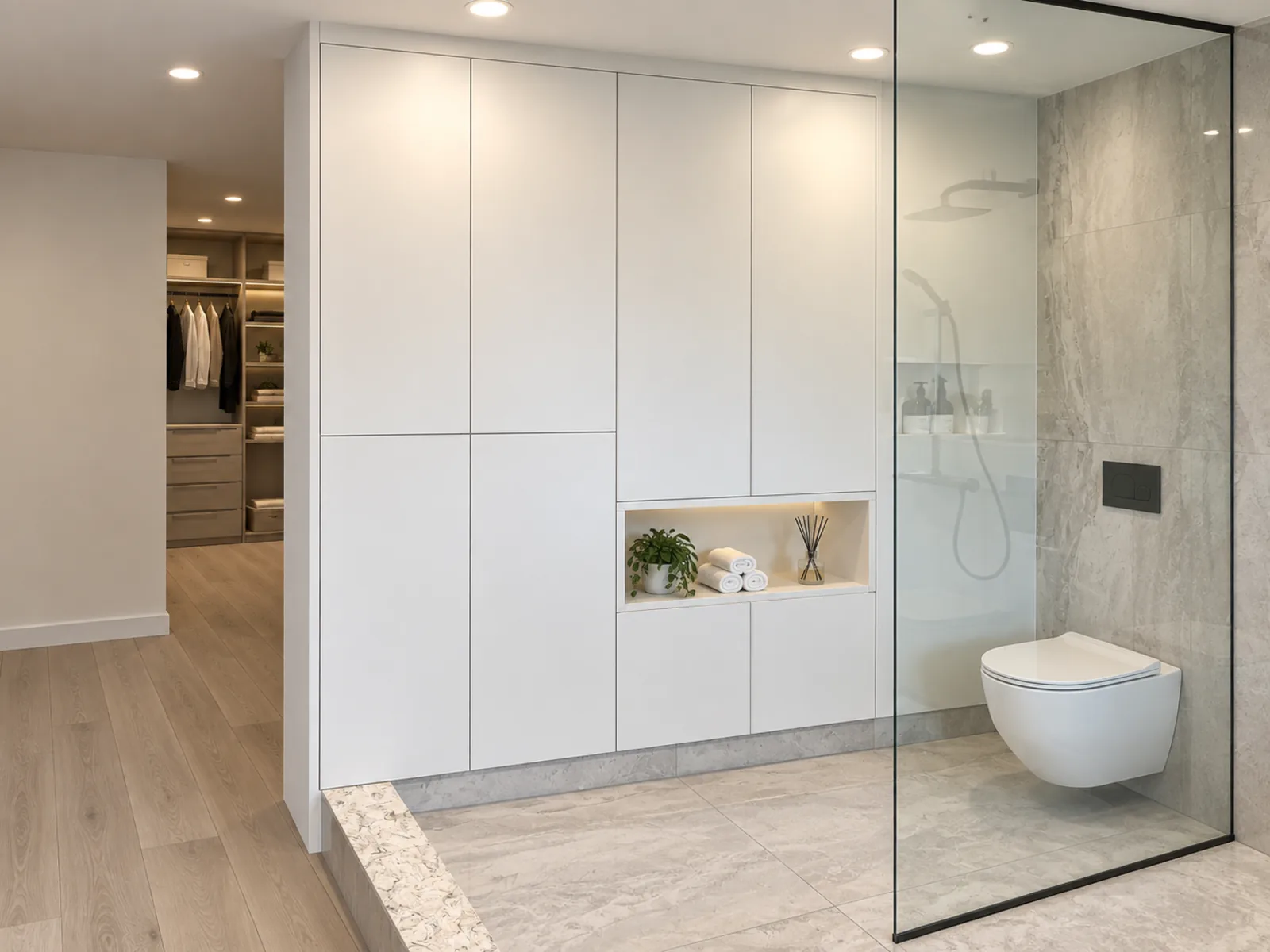 Completed Roomidea washroom with a custom cabinet beside the toilet dividing the washroom from the adjoining walk-in closet