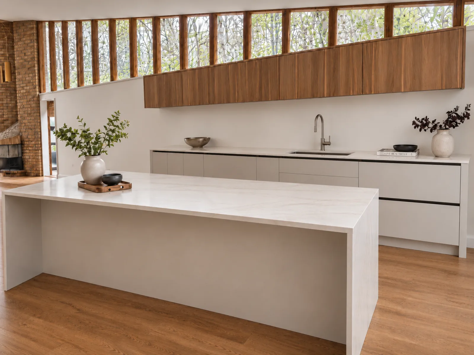 Completed modern kitchen with floating woodgrain upper cabinets, low grey cabinetry and a broad white island