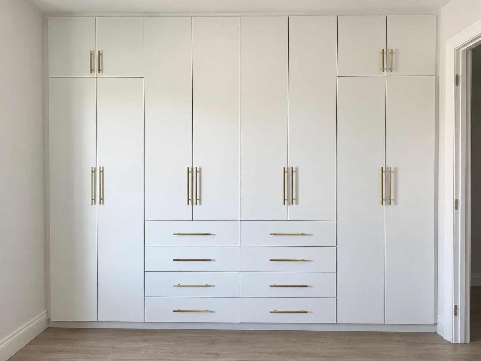 Wall-to-wall built-in wardrobe with full-height doors and integrated drawers