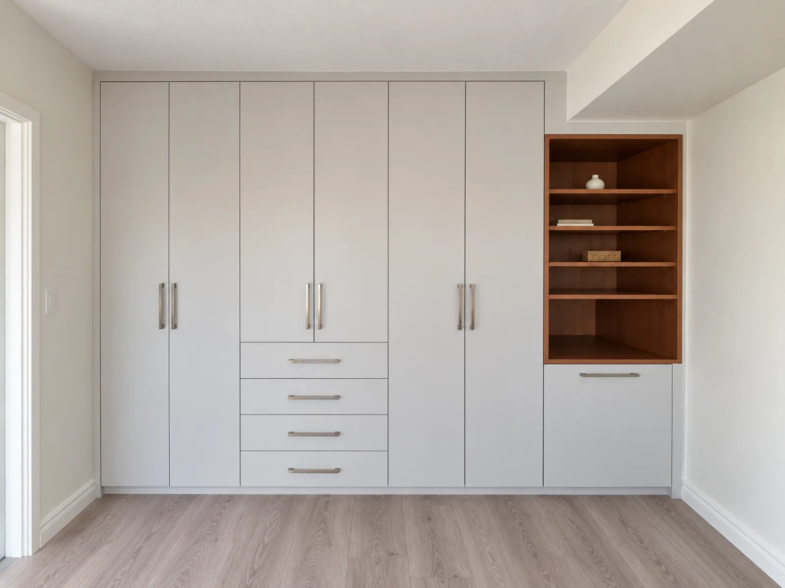 Built-in wardrobe with open shelving designed beneath an existing bulkhead