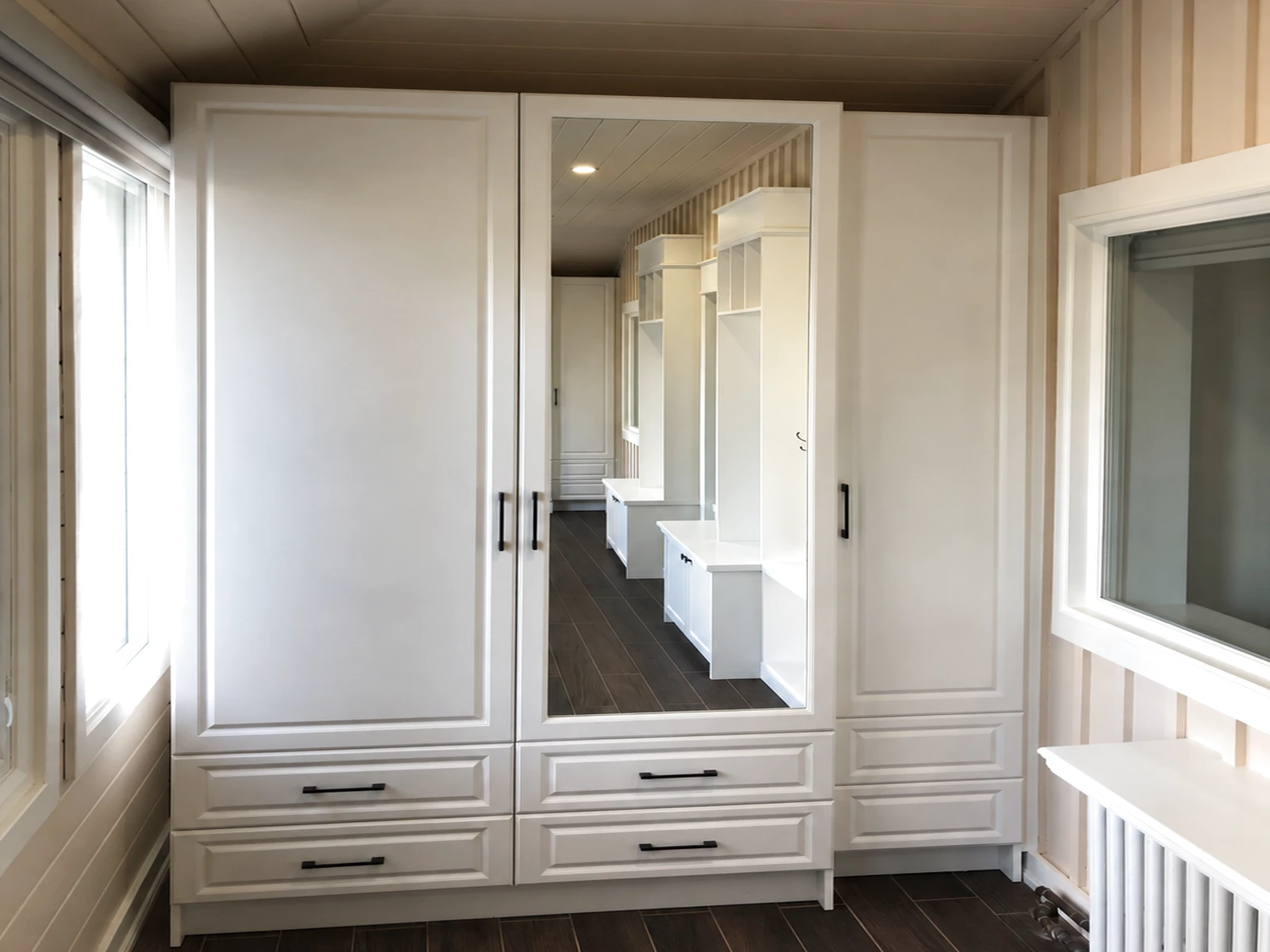 Two freestanding wardrobes of different depths including a mirrored door
