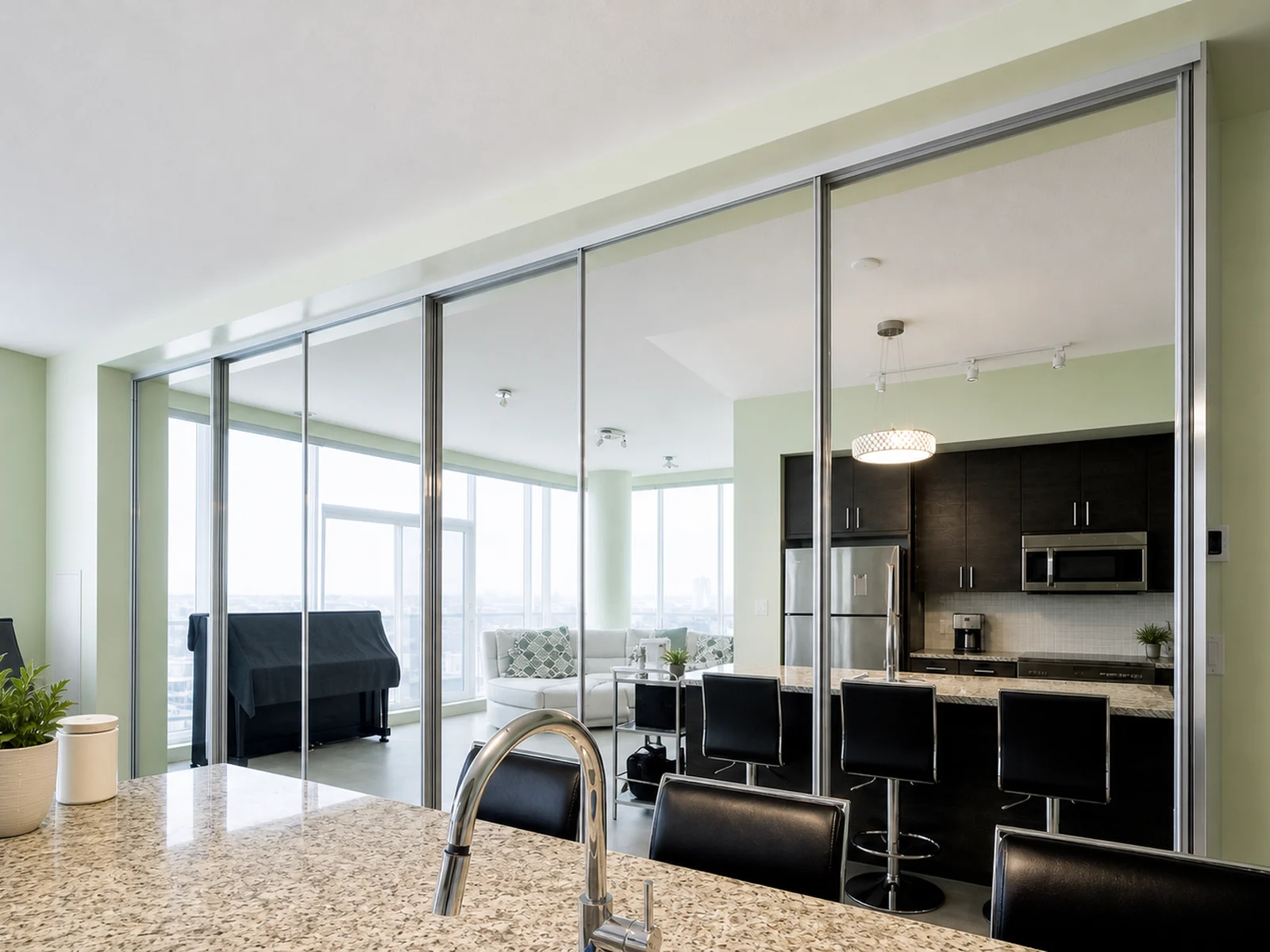 Mirrored sliding closet doors installed across a full-wall bedroom storage opening.