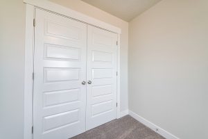 Linen Or Wardrobe Closet With Closed White Double Doors Inside A Linen or wardrobe closet with closed white double doors inside a house
