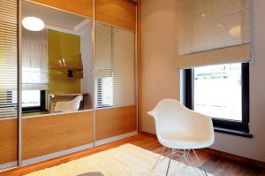 Cabinet Modern wardrobe with sliding door and mirror in bedroom interior