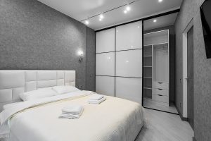 Master Bedroom With Sliding Wardrobe And Balcony Door. Elegant A Master bedroom with sliding wardrobe and balcony door. Elegant and comfortable hotel bedroom interior